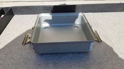 Silver rectangular metal sterilization container without lid featuring rounded corners and two circular indentations