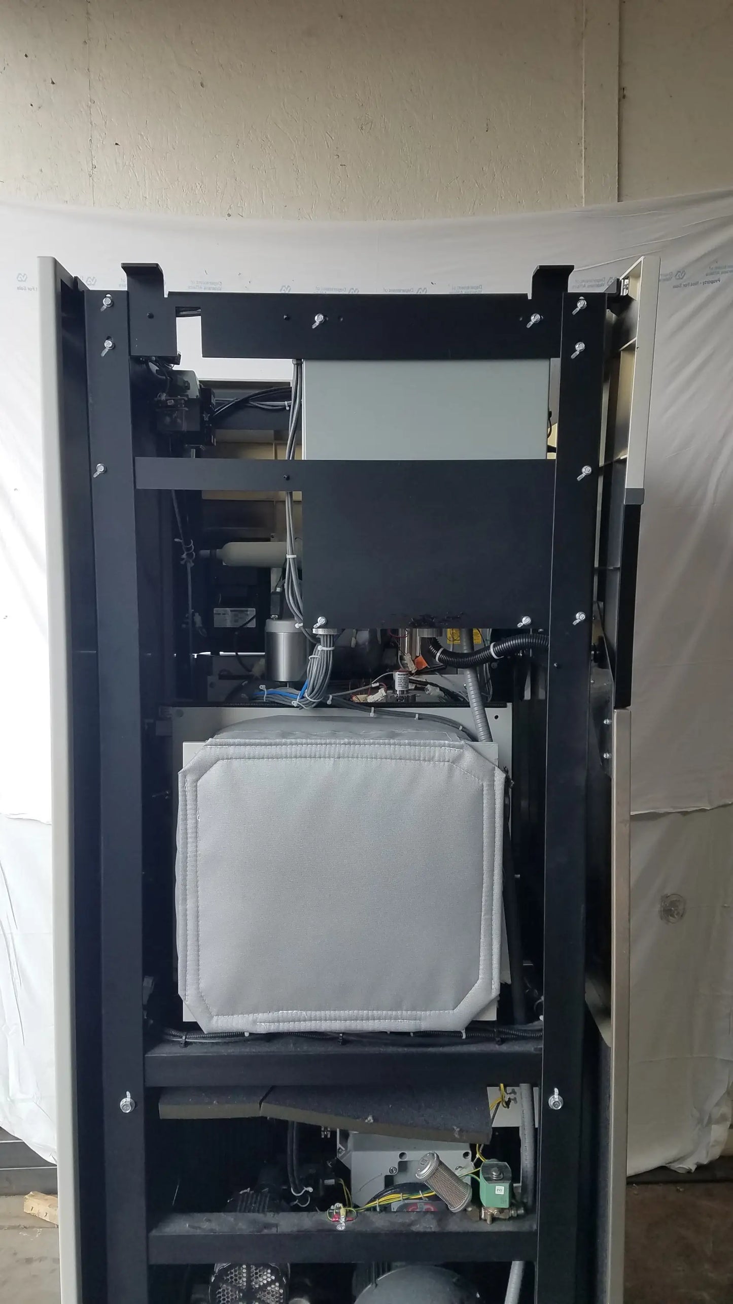 Black metal industrial frame with white padded compartment in Steris V-Pro Max low temperature sterilization system