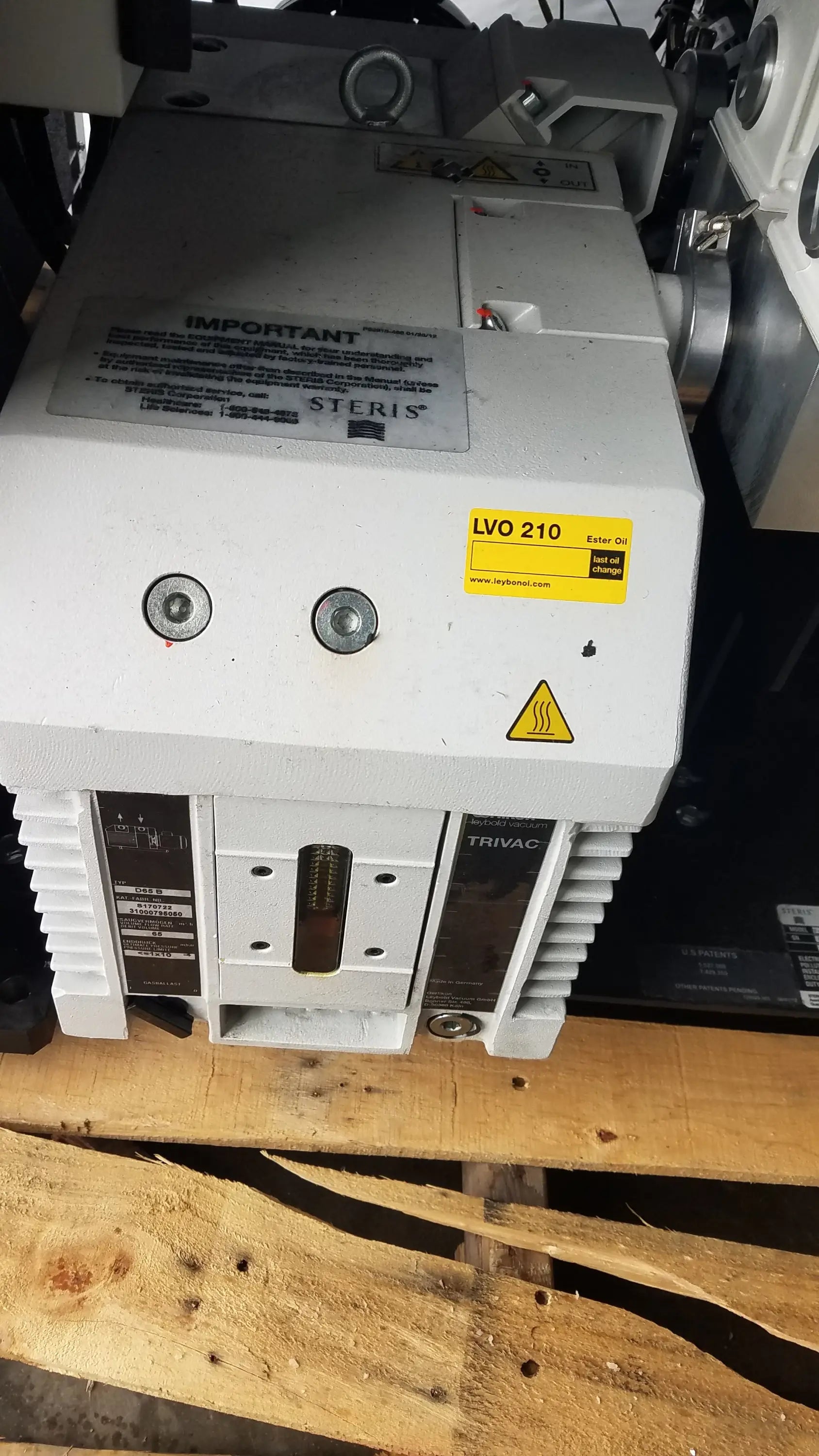 White steris v-pro max industrial sterilizer unit with yellow warning labels for low temperature sterilization use
