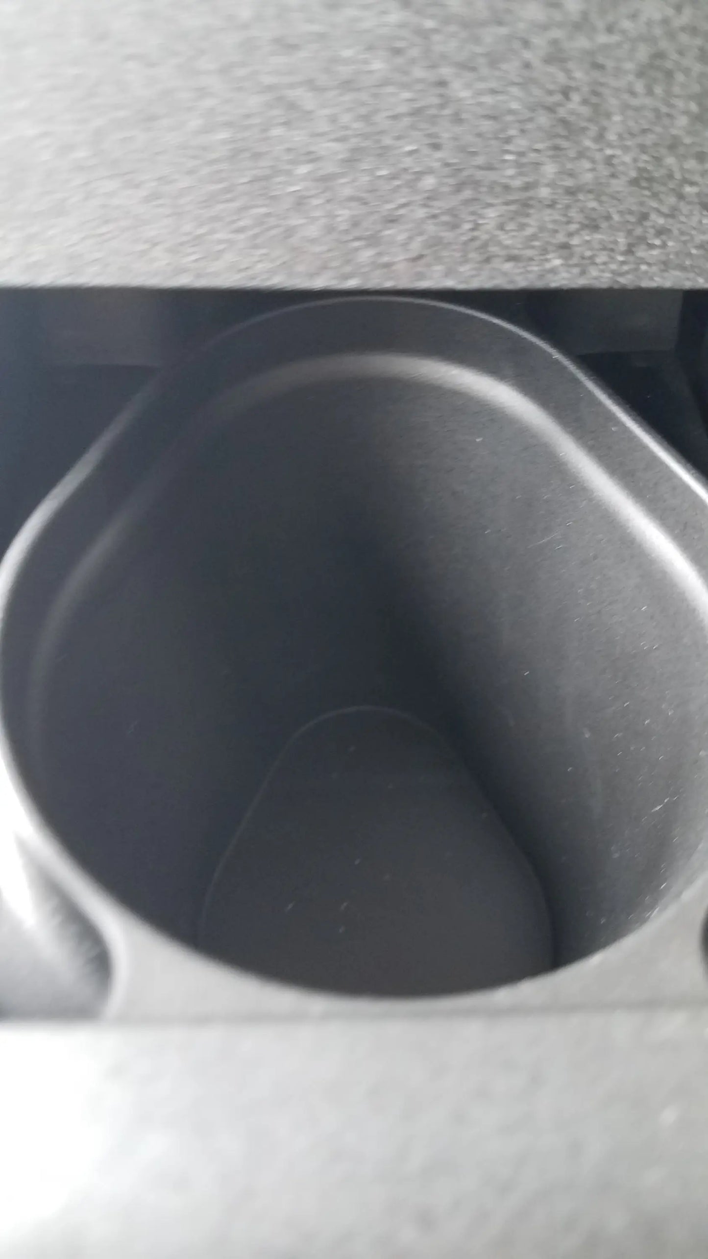 Black plastic cup holder with rounded edges and textured interior for steris v-pro max low temperature sterilization system