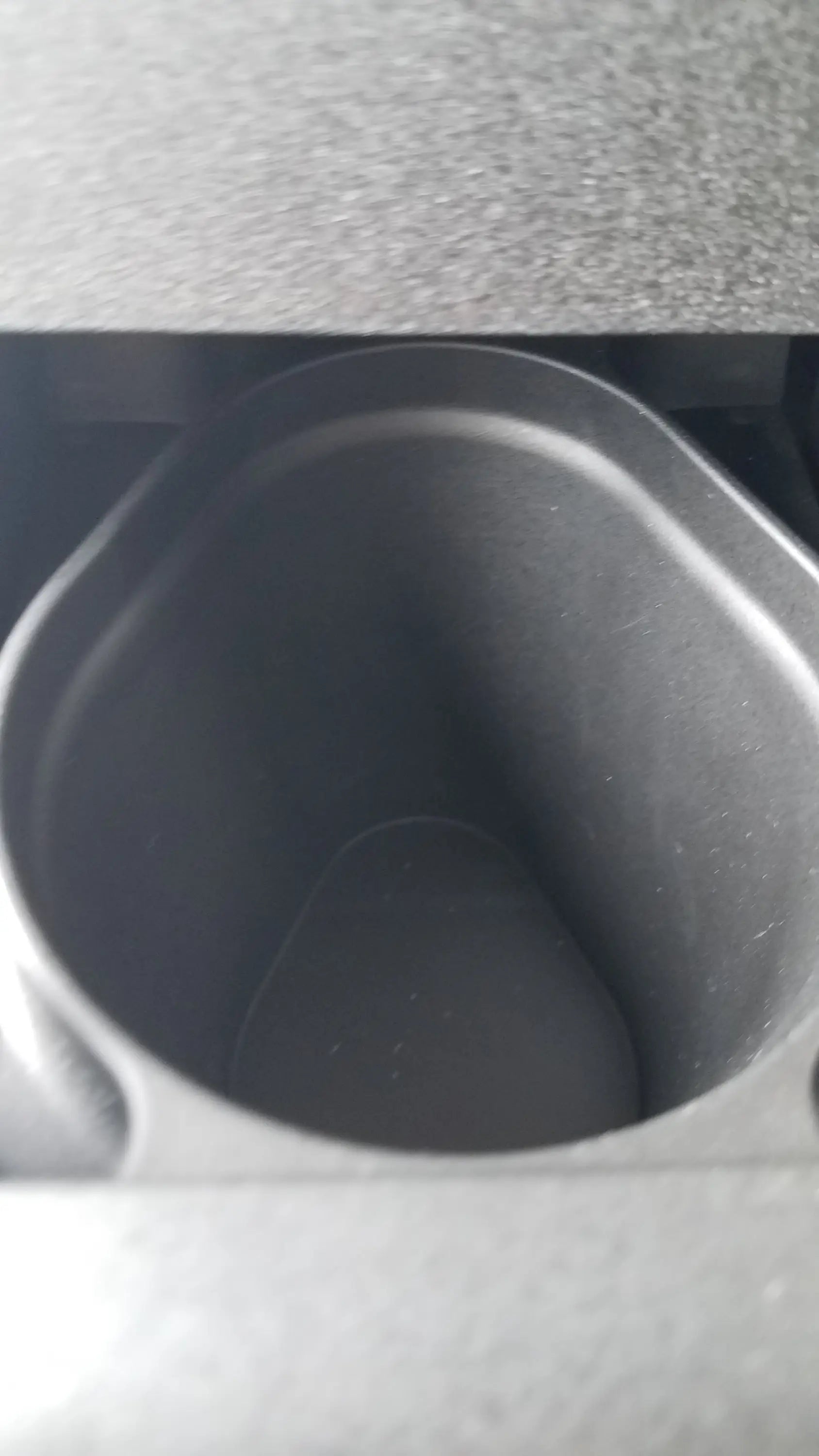 Black plastic cup holder with rounded edges and textured interior for steris v-pro max low temperature sterilization system