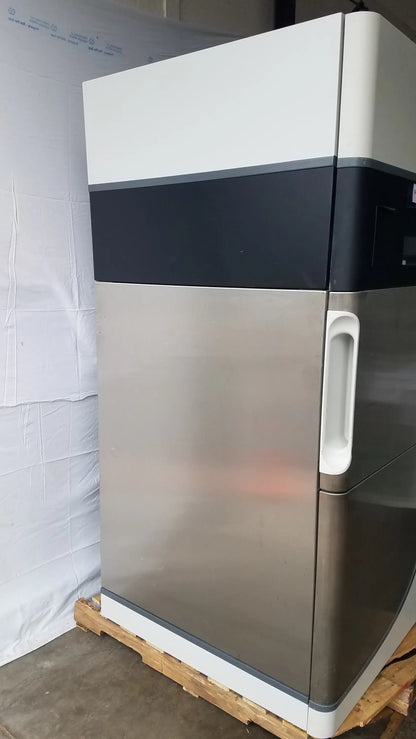 A sleek stainless steel steris v-pro max low temperature sterilization system with white and black accent stripe
