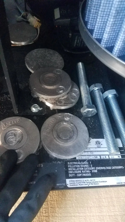 Silver metallic flanges with bolt holes and stamped markings beside threaded bolts on steris v-pro max low temperature sterilization system