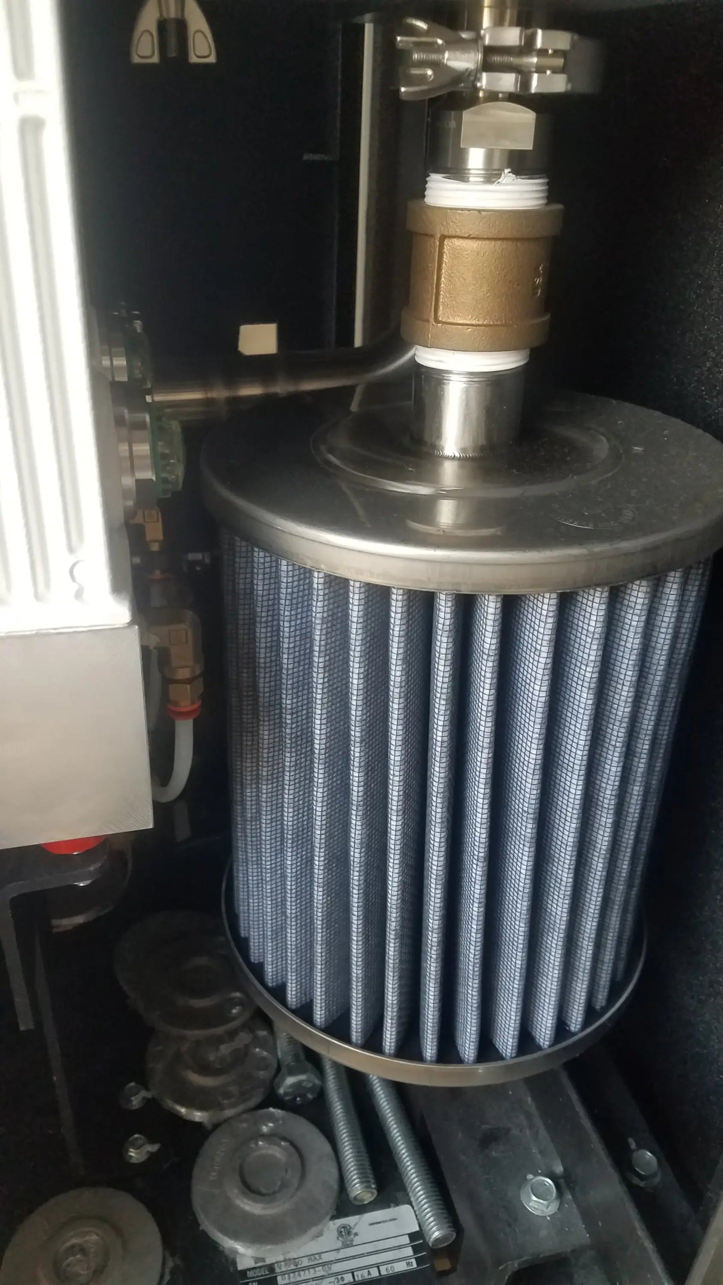 Blue pleated air filter with metallic top and base mounted in steris v-pro max low temperature sterilization system