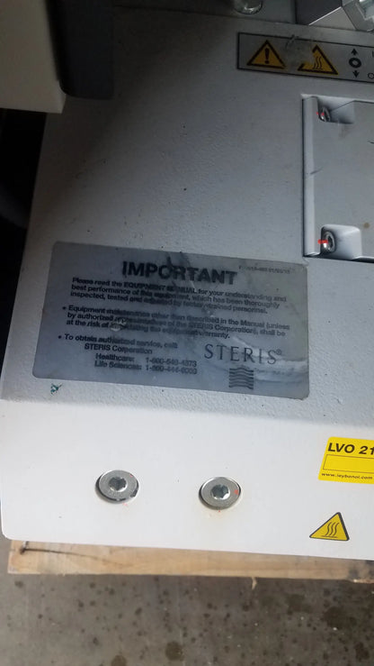 Steris lvo 210 low temperature sterilization system with white metallic casing and safety warning labels serial 0324713-05