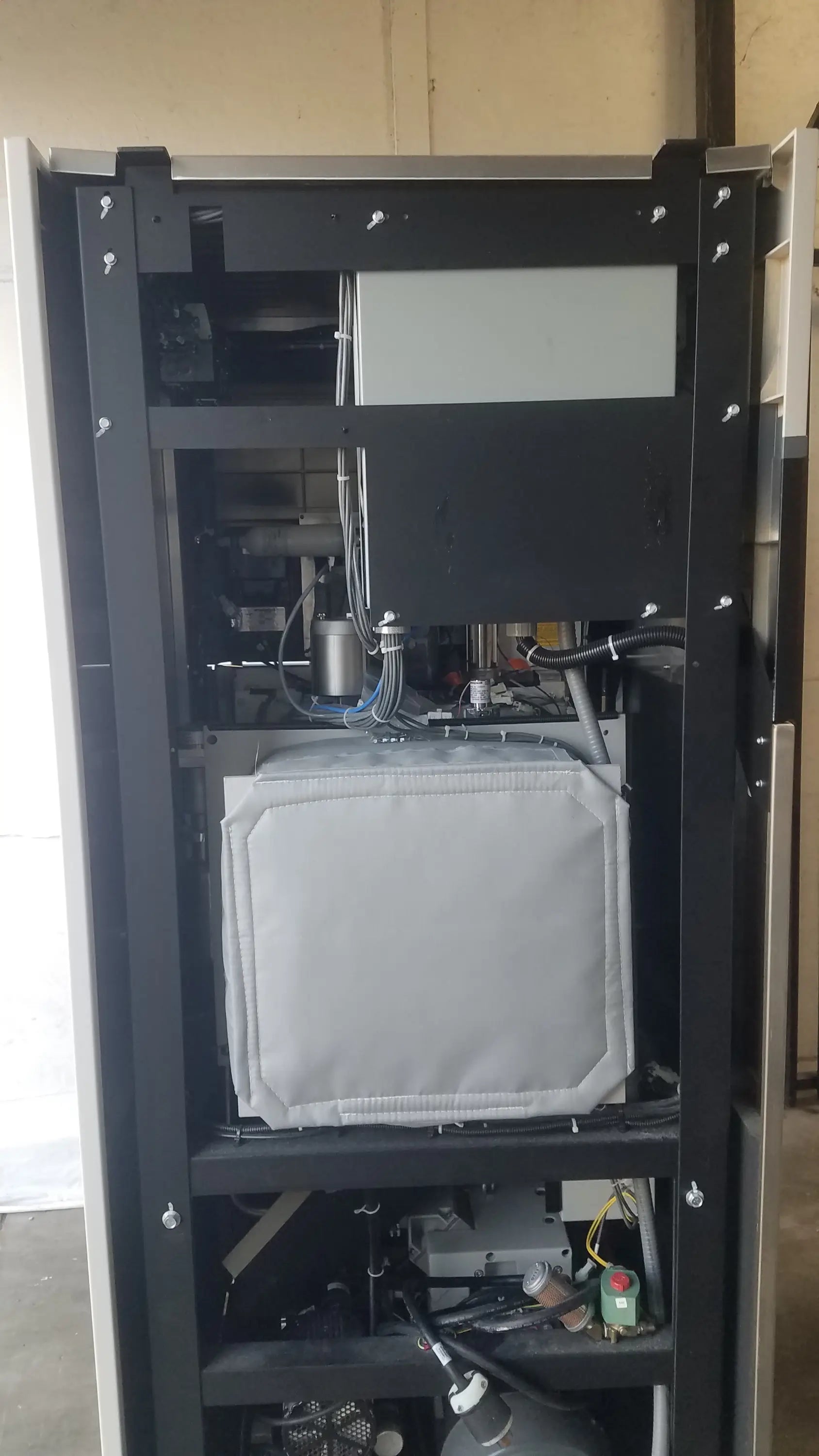 Black metal server rack with internal components and gray padded compartment for steris v-pro max low temperature sterilization system