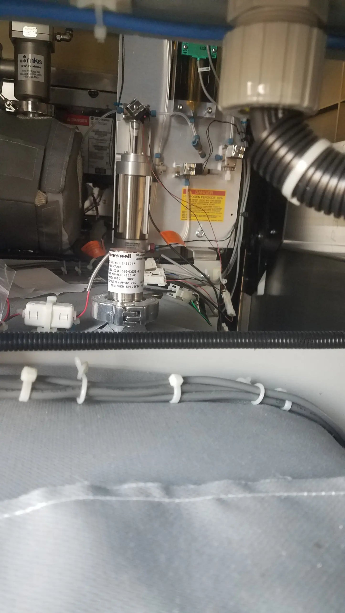 Silver cylindrical honeywell motor with metallic finish and labeled components in steris v-pro max low temperature sterilization system