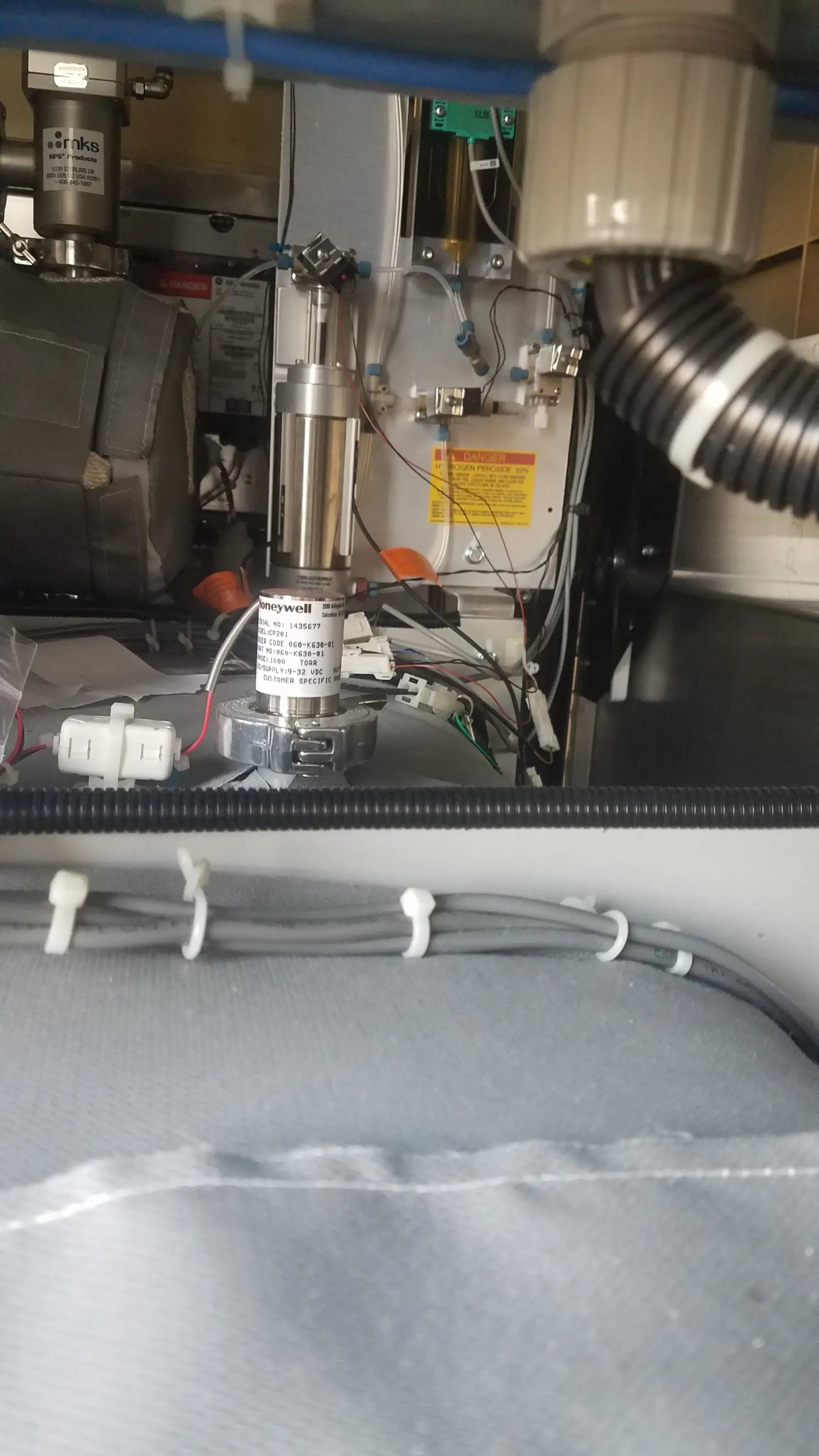 Silver cylindrical honeywell motor with metallic finish and labeled components in steris v-pro max low temperature sterilization system