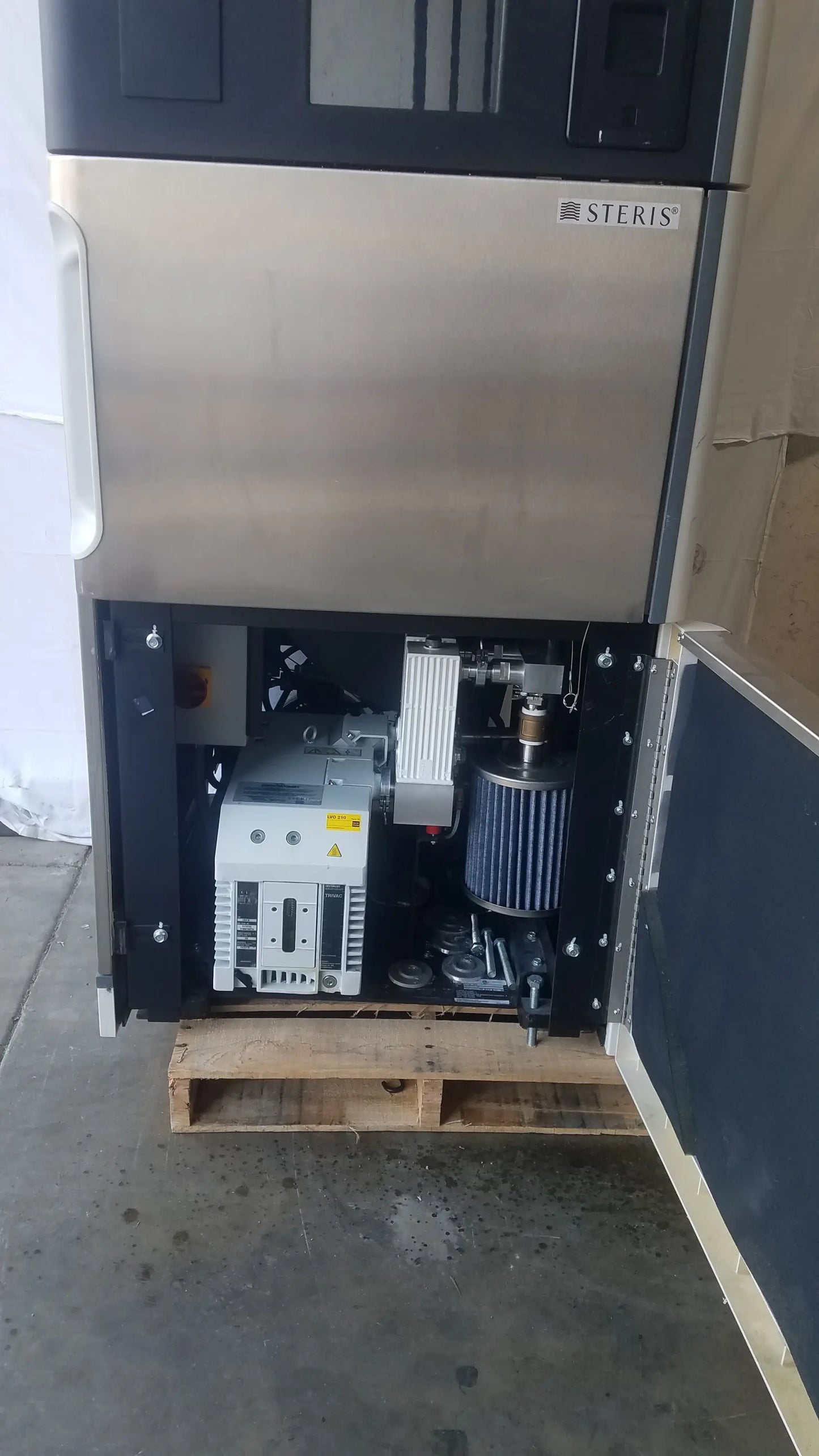 Steris v-pro max low temperature sterilization system with stainless steel exterior and visible internal components includes white control unit and blue filter