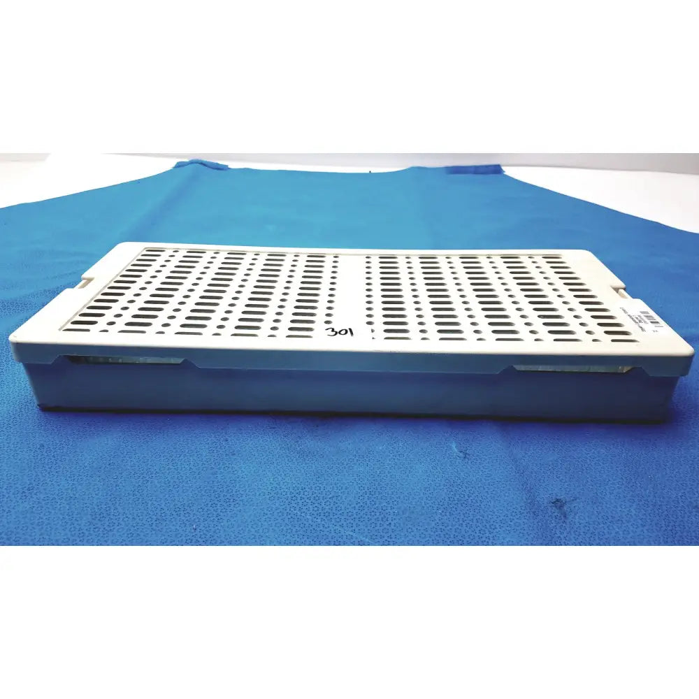 Sterrad NX standard white plastic surgical instrument tray with perforated top and blue base for standard sterilization container