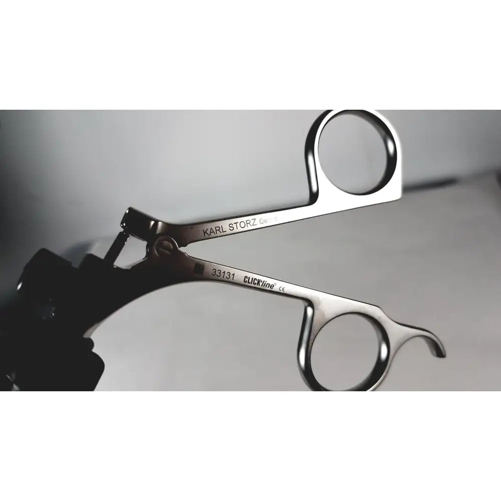 Silver storz laparoscopy forceps with polished stainless steel surgical finish and engraved karl storz branding
