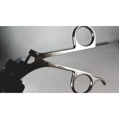 Silver storz laparoscopy forceps with polished stainless steel surgical finish and engraved karl storz branding
