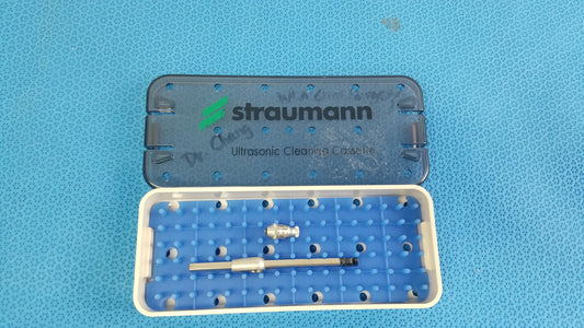 Blue and white plastic Straumann ultrasonic cleaning cassette with silver surgical instruments for reuse medical equipment
