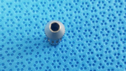 Gray metallic gear with hexagonal center and serrated edge for straumann ultrasonic cleaning cassette in medical equipment reuse