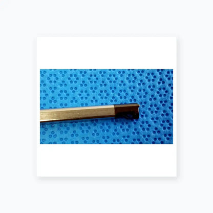 A metallic cylindrical medical equipment tool with a black angled cutting tip for reuse ultrasonic cleaning