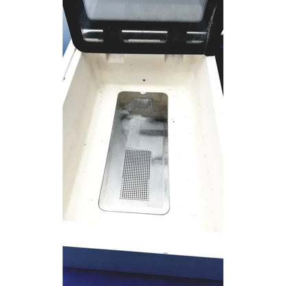 A rectangular perforated metal tray with a reflective surface inside an open white container for straya ref strava splint bath