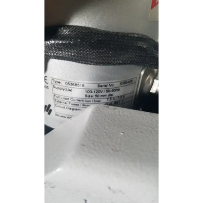 Gray textured cylindrical electrical component with white label on struers prontopress-20 dual-cylinder metallographic specimen hot mounting machine