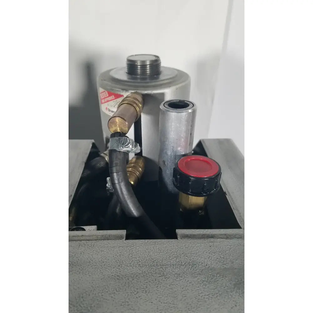 Silver cylindrical industrial component with brass fittings and red cap of struers prontopress-20 dual-cylinder metallographic specimen hot mounting machine