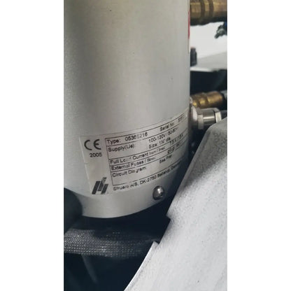 Silver cylindrical industrial pump with label on struers prontopress-20 dual-cylinder metallographic specimen hot mounting machine