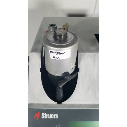 Silver cylindrical industrial pump with black handle on struers prontopress-20 dual-cylinder metallographic hot mounting machine
