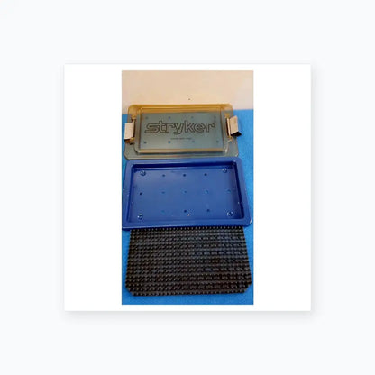 Stryker lightweight sterilization box medical equipment with blue plastic base and textured gray rubber insert for reuse medical equipment