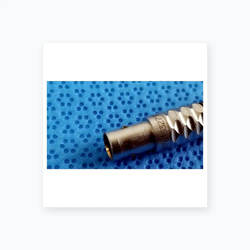 Silver-colored metal bnc connector with threaded exterior and engraved serial number on stryker lightweight sterilization box for medical equipment reuse