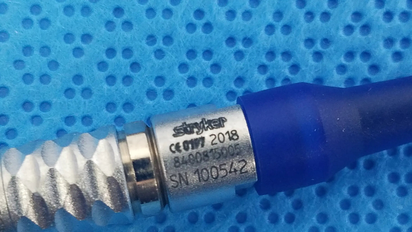 Silver-colored metallic connector with blue cap engraved stryker serial number for lightweight sterilization box medical equipment