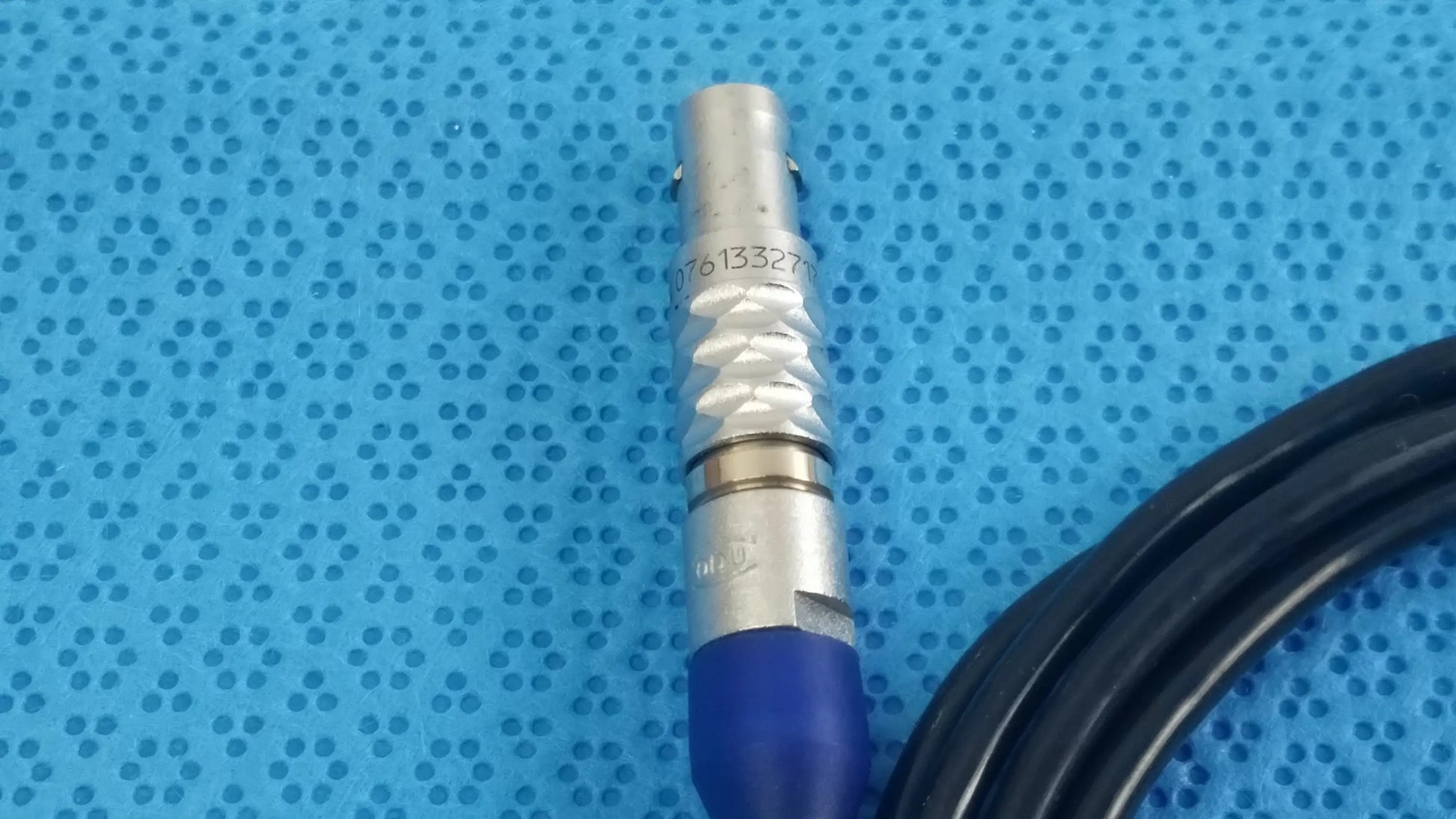 Silver bnc connector with blue insulated cable on the back side of stryker 0406-650-400 medical equipment box for reuse medical equipment