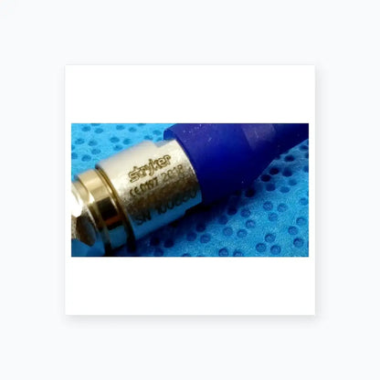 Blue and silver stryker medical connector with engraved serial number for reuse medical equipment in sterilization box
