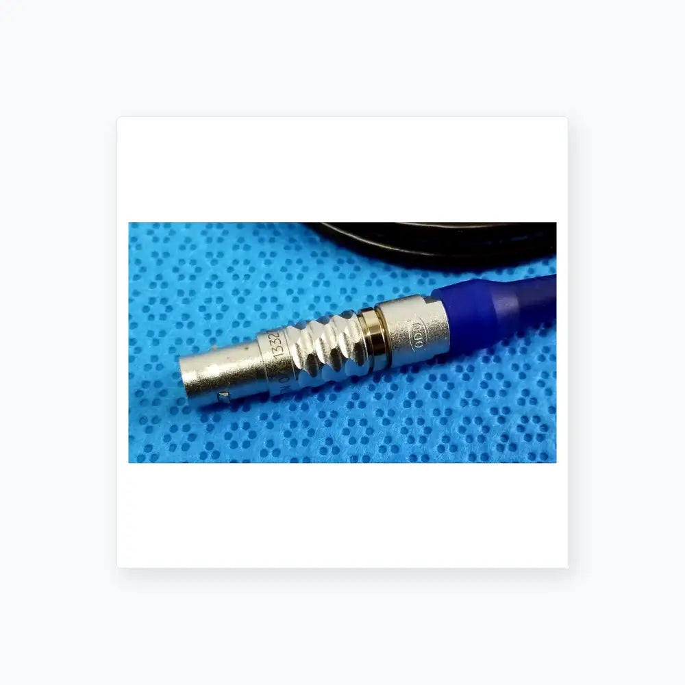 Silver metallic bnc connector with blue strain relief and engraved markings on stryker multigen 2 sterilization box for reuse medical equipment