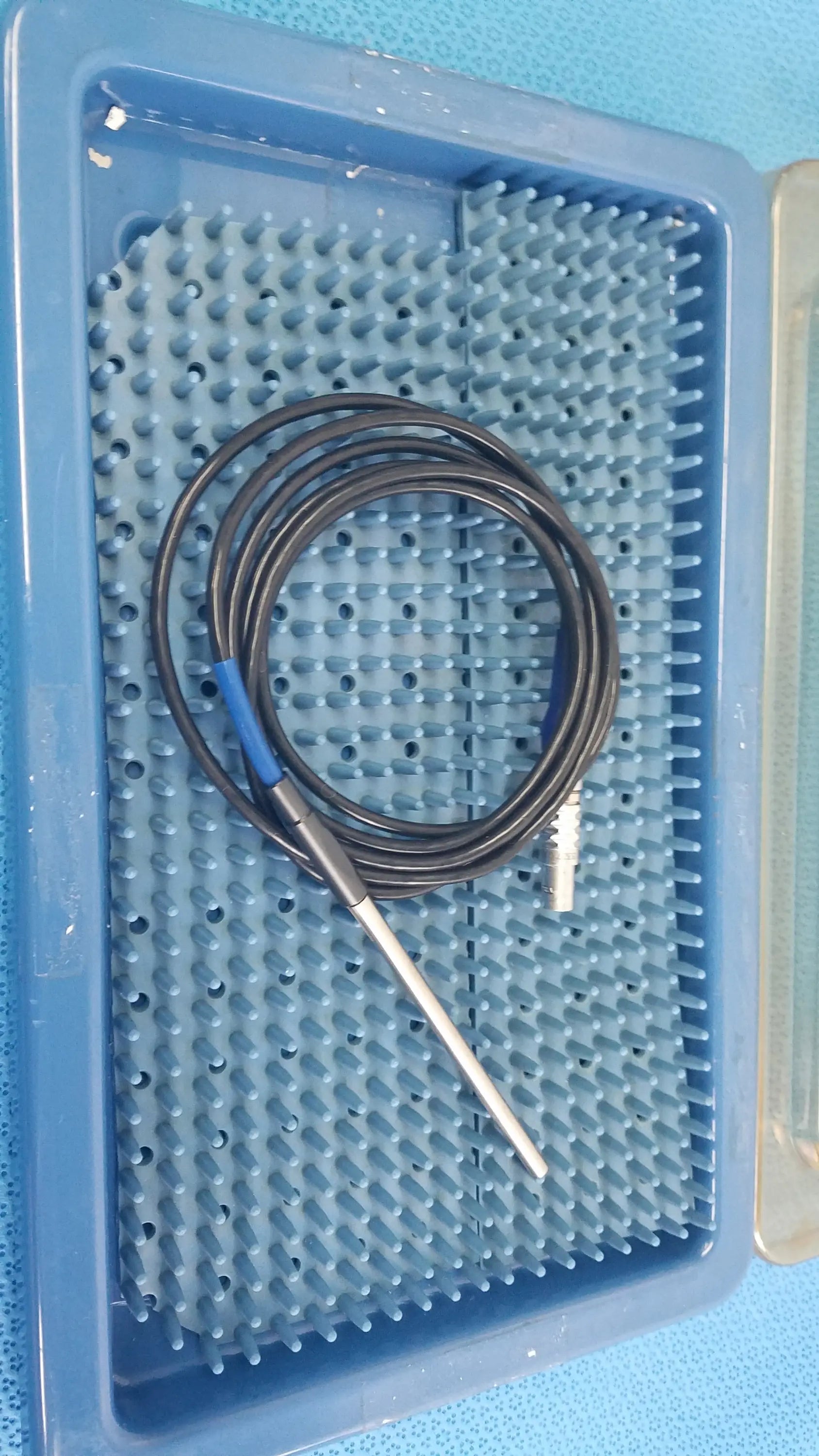 Stryker 0406-650-400 multigen 2 sterilization box with coiled black electrode probe and blue connector for reuse medical equipment