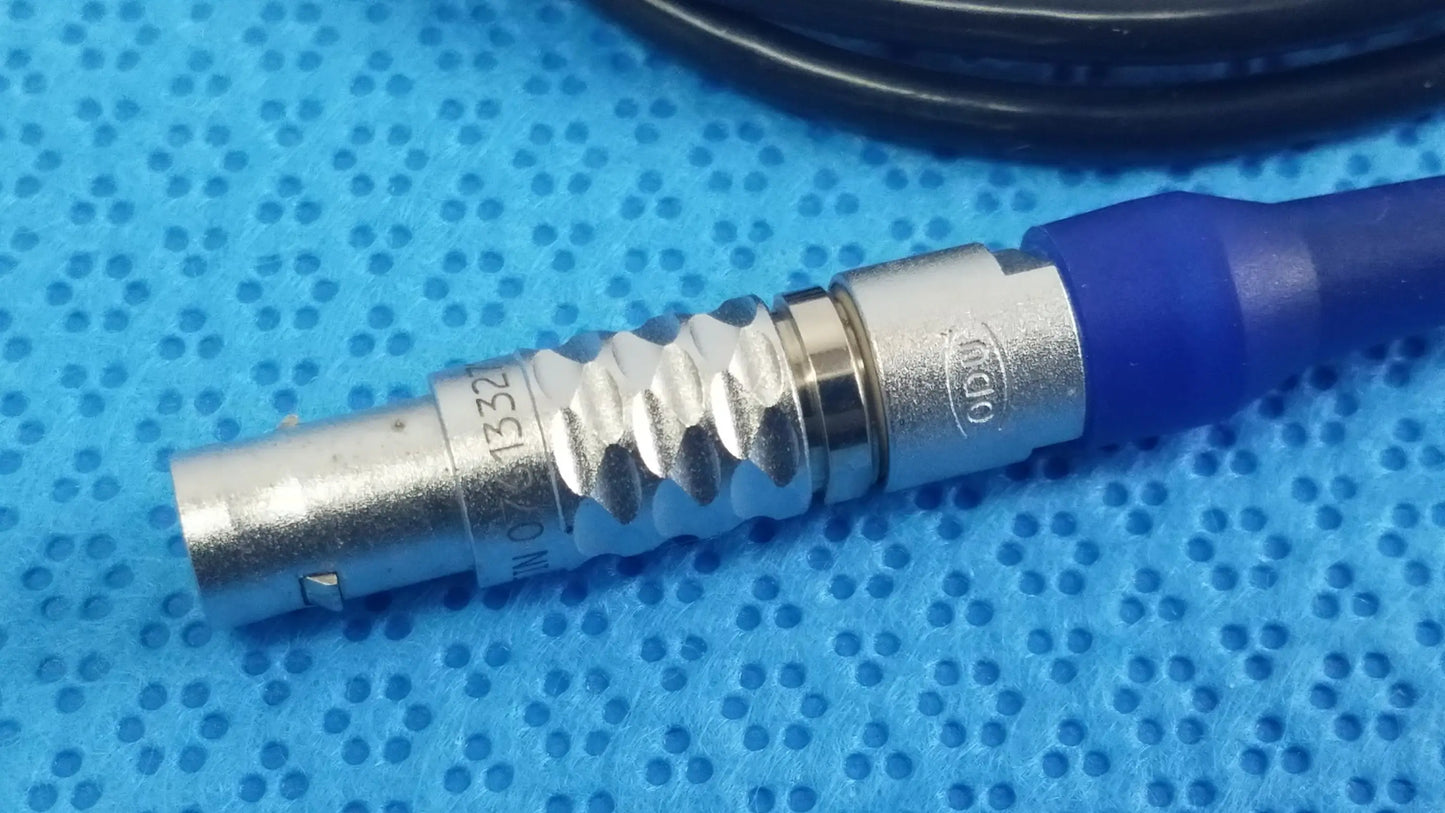 Silver metallic bnc connector with blue strain relief and engraved markings on stryker multigen 2 sterilization box for reuse medical equipment