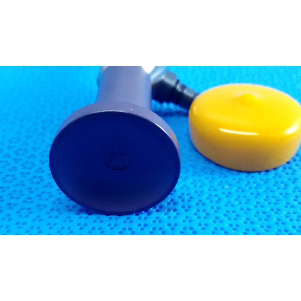 Dark blue cylindrical pressure gauge with yellow cap beside stryker precision 10mm 0° autoclavable endoscope for reuse medical use