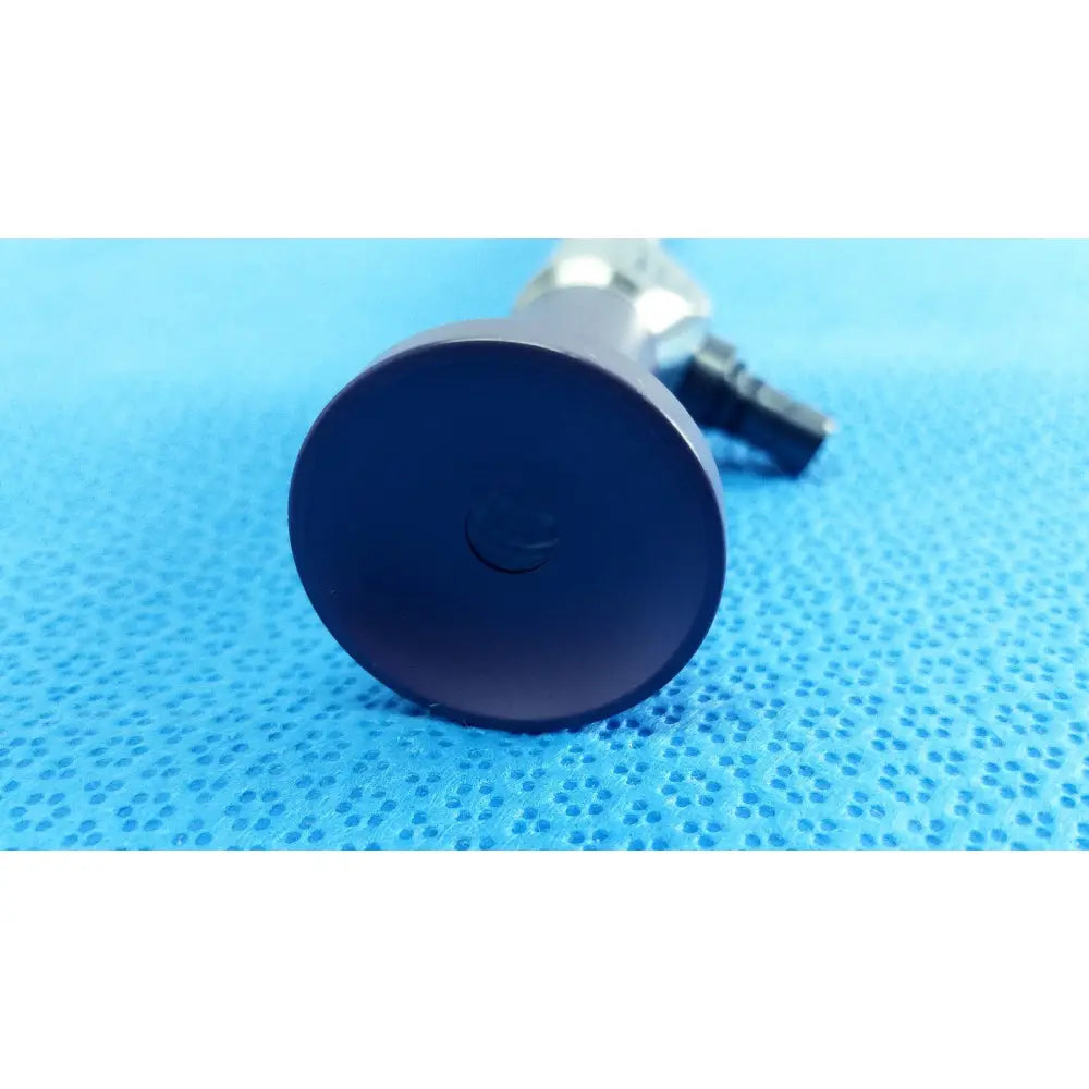 Dark blue circular push button with matte finish and metallic connector on stryker 0502-103-030 precision 10mm 0° autoclavable endoscope