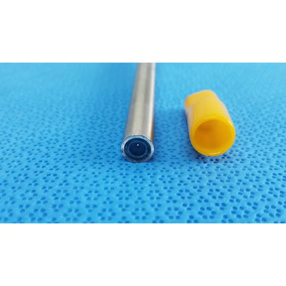Silver-colored Stryker precision 10mm 0° autoclavable endoscope with a yellow plastic cap beside it