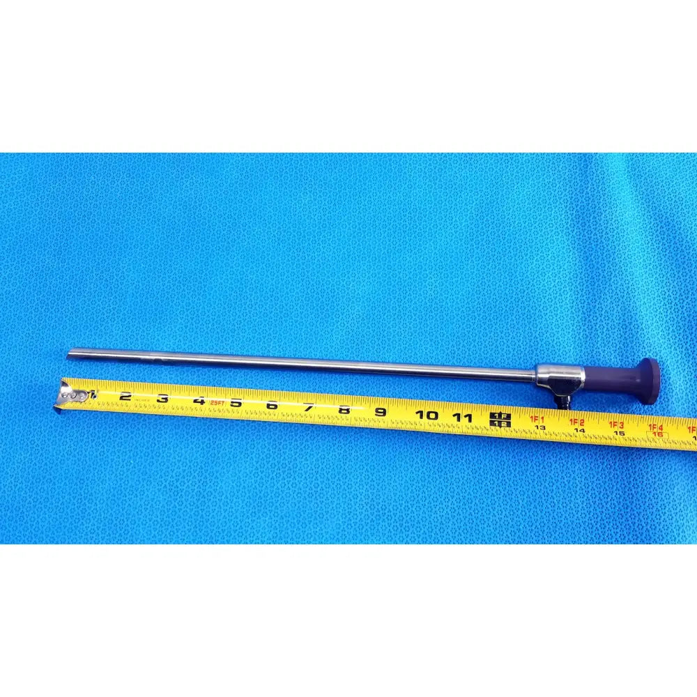 Silver surgical precision 10mm 30° autoclavable endoscope with purple handle beside yellow measuring tape