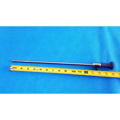 Silver surgical precision 10mm 30° autoclavable endoscope with purple handle beside yellow measuring tape