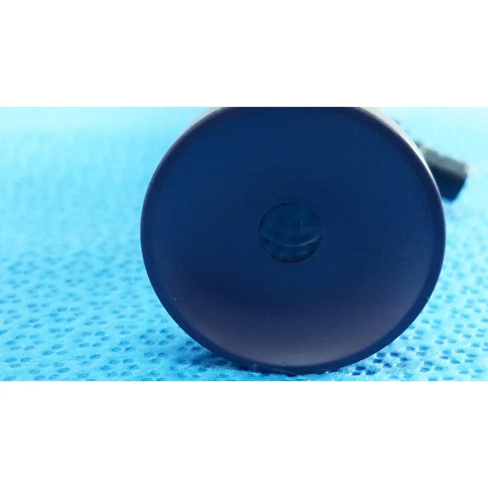 Dark blue circular base with small central indentation of stryker precision 10mm 30° autoclavable endoscope back side