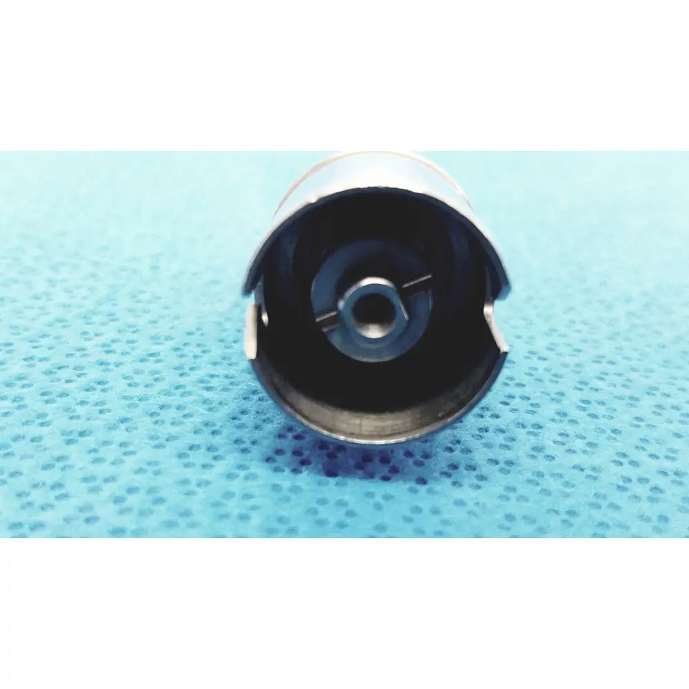 Silver-colored metal Stryker 1:1 bur attachment 4100-600-000 bobbin case with black interior for reuse medical use