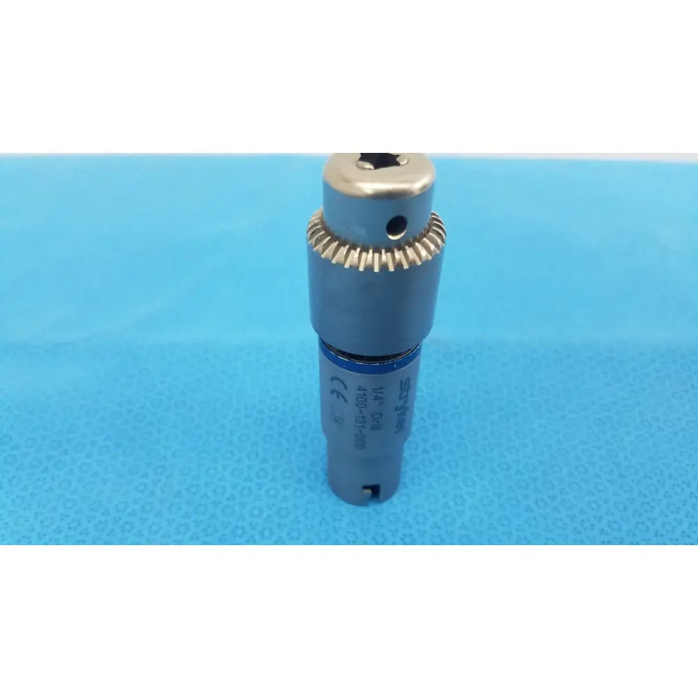 Silver-colored metal Stryker 1/4 inch drill attachment with gear-like ring and markings for reuse medical orthopedic instruments