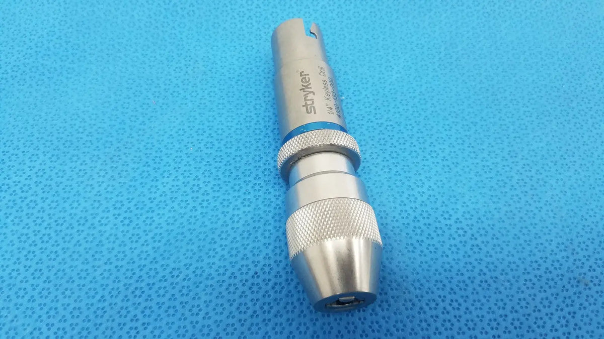 Silver stryker 1/4 keyless drill with textured grip and blue accent band for reuse medical applications