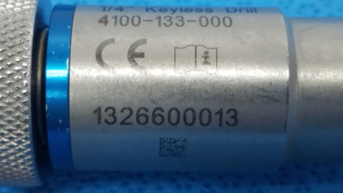 Silver metallic stryker 1/4 keyless drill with blue accent ring and engraved labeling for reuse medical applications