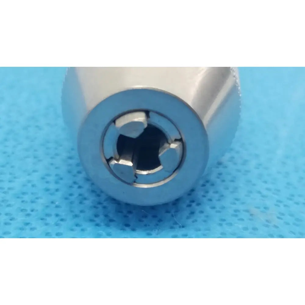 Silver-colored metallic cylindrical keyless drill with cross-shaped internal keyway for reuse medical applications