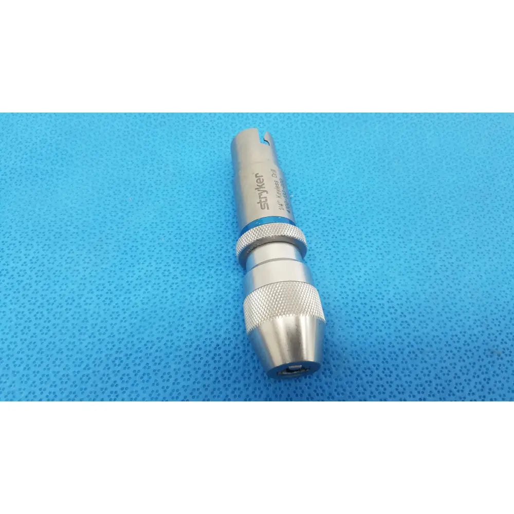 Silver stryker 1/4 keyless drill with textured grip and blue accent band for reuse medical applications