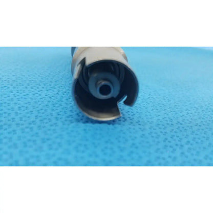 Silver metallic cylindrical component with spiral internal mechanism and cut-out edges for stryker keyless drill reuse medical