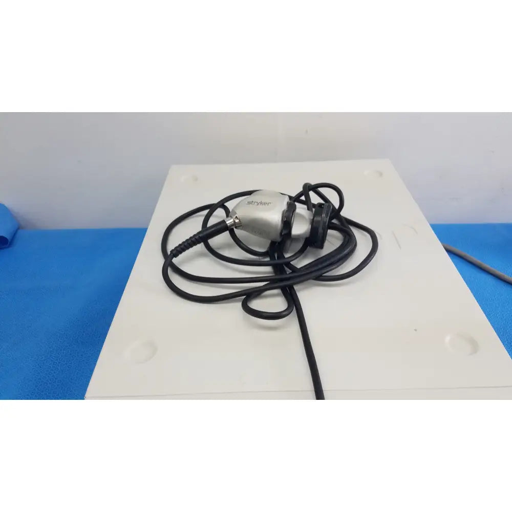 Silver stryker surgical endoscope with black coiled cable for reuse medical applications featuring camera head and coupler