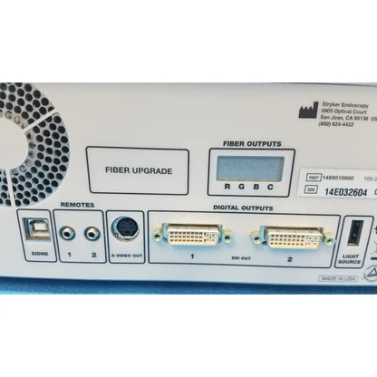 Rear panel of white stryker 1488 hd camera system with camera head showing fiber upgrade digital outputs and remotes ports