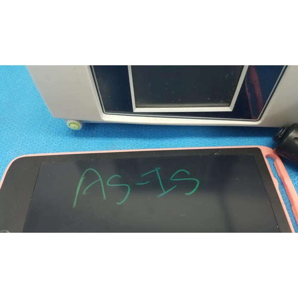 Pink-framed digital writing tablet displaying green text alongside Stryker 1488 HD camera system with camera head and coupler for reuse medical applications