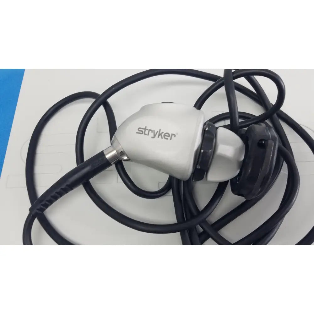 Stryker 1488 HD camera system with camera head featuring a white handle and black flexible reuse medical tubing
