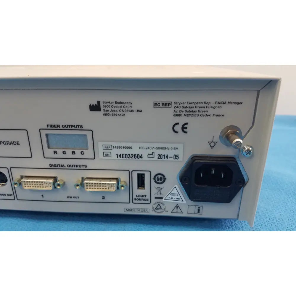 White plastic stryker 1488 hd camera system back panel showing labeled fiber and digital output ports with camera head for reuse medical use